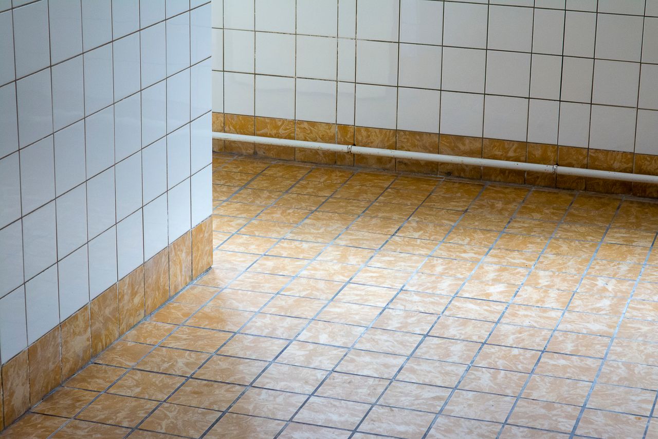 Crafting Captivating Headlines: Your awesome post title goes here A clean, empty interior space with tiled flooring and walls, showcasing minimalist design.
